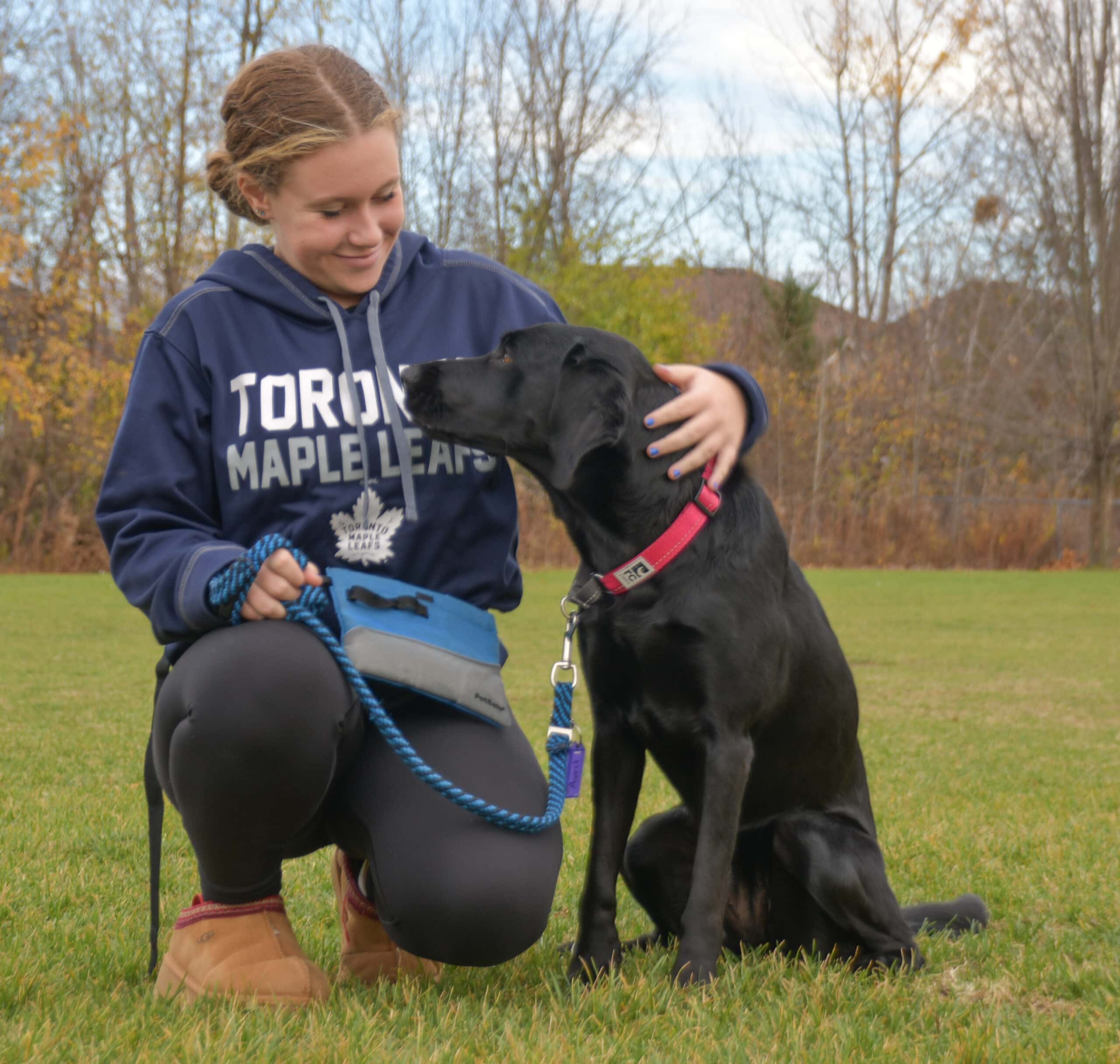 student trainer with black lab