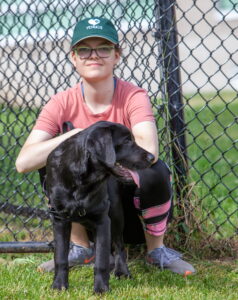 black lab with student trainer