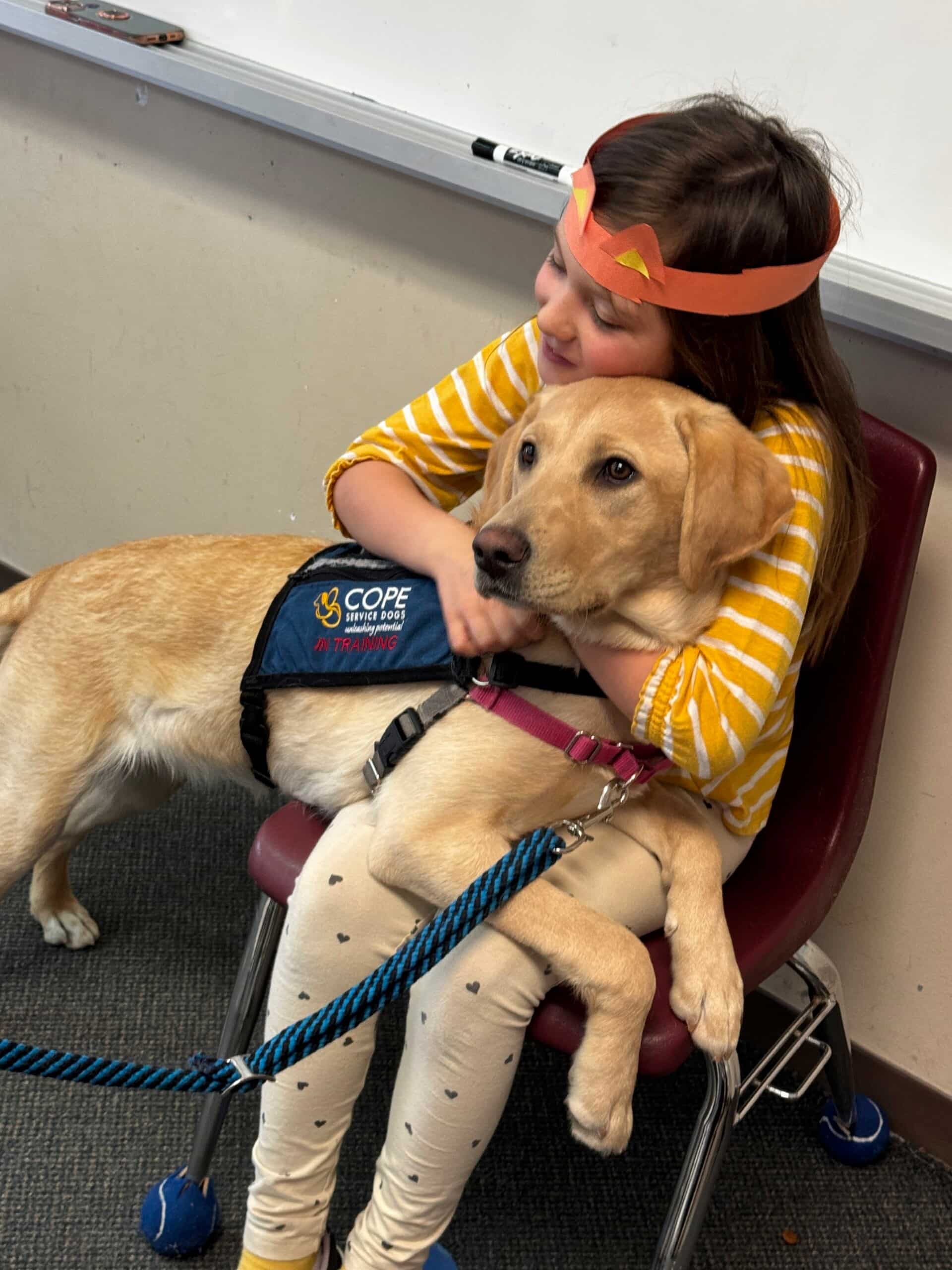 girl with dog on her lap sitting in chair